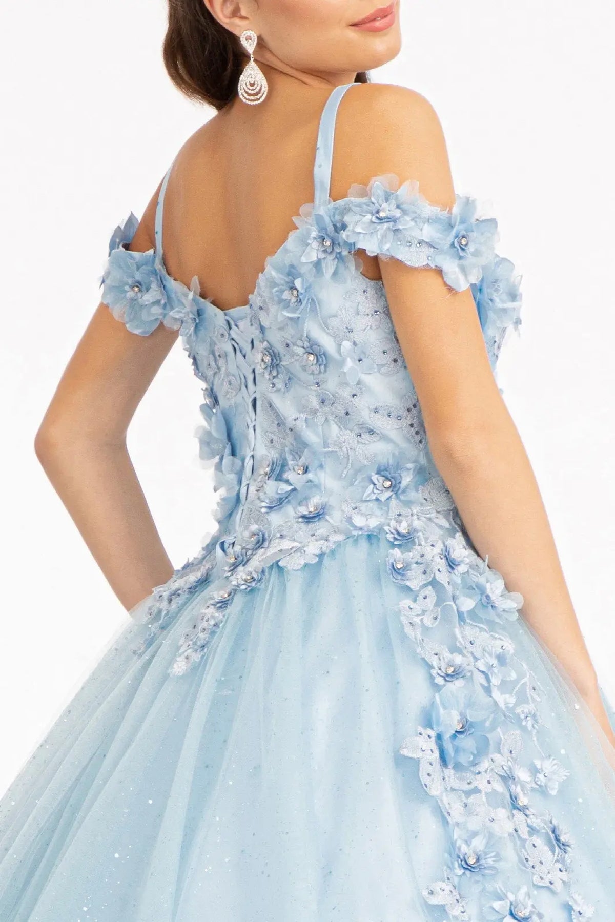 Layered skirt showcases the Baby Blue quinceañera ball gown with 3d floral appliqués.