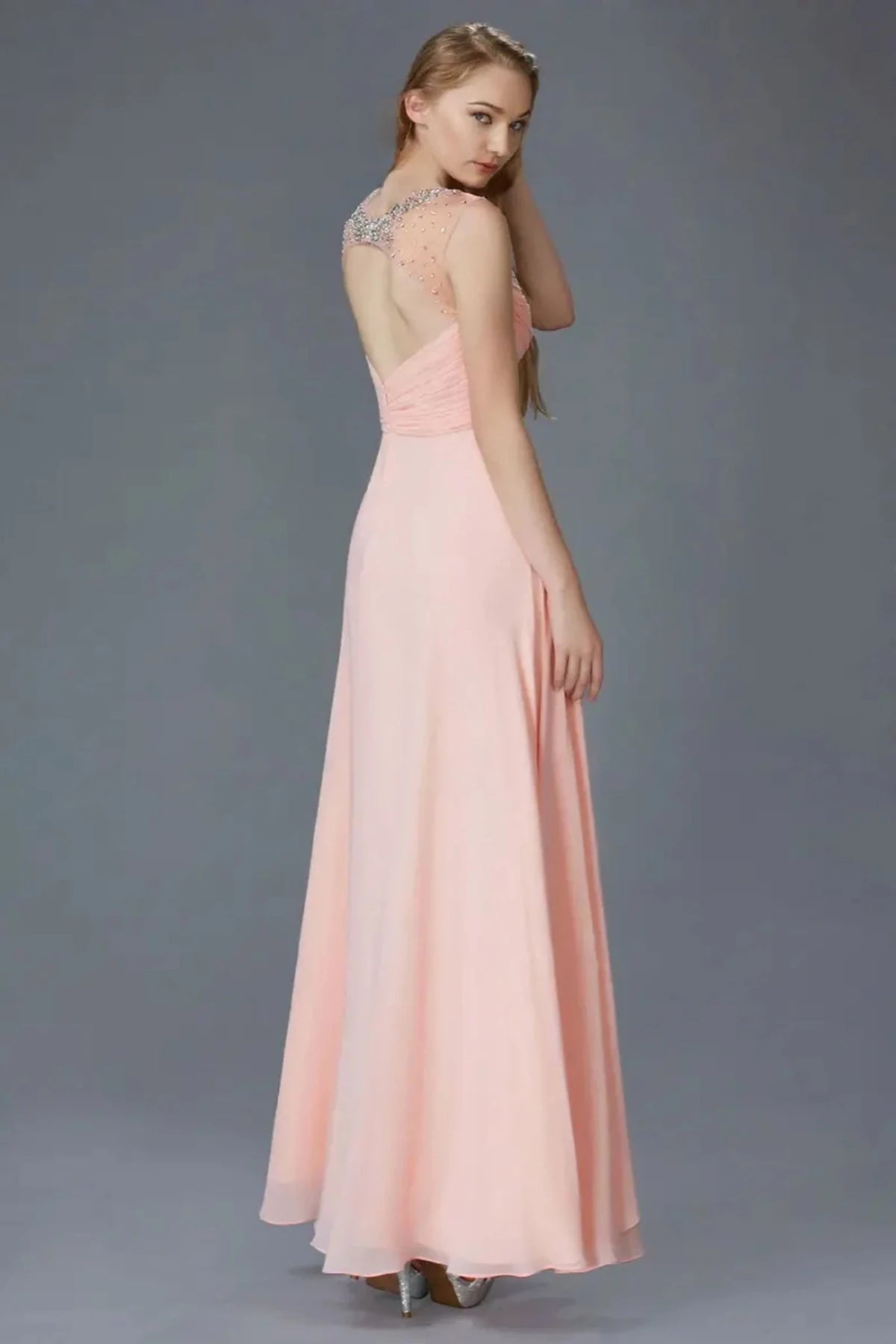 Rear view highlights the open back of the Blush prom evening dress.