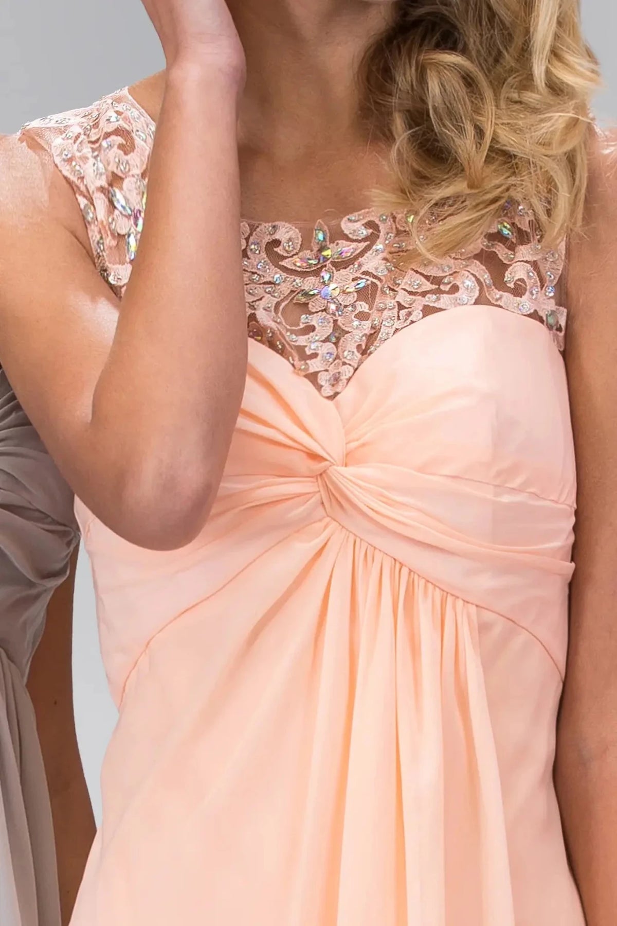 Bodice close-up reveals jewel accents across the illusion sweetheart upper bodice of the Peach prom evening dress.