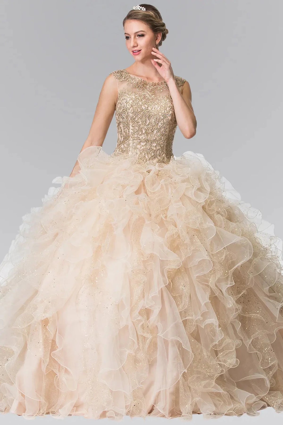 Displayed in full, the Champagne quinceañera ball gown features a gold-embroidered bodice and voluminous champagne ruffles.