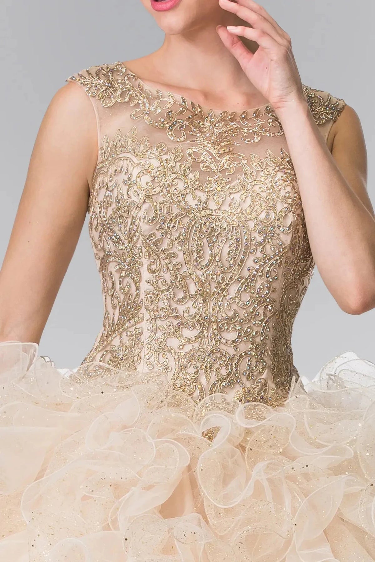 A front bodice close-up emphasizes ornate gold embroidery across the sheer neckline on the Champagne quinceañera ball gown.
