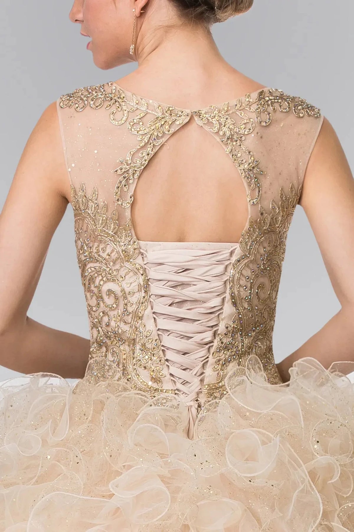 Viewed in a back bodice close-up, the Champagne quinceañera dress presents a cutout back framed by beadwork and satin lacing.
