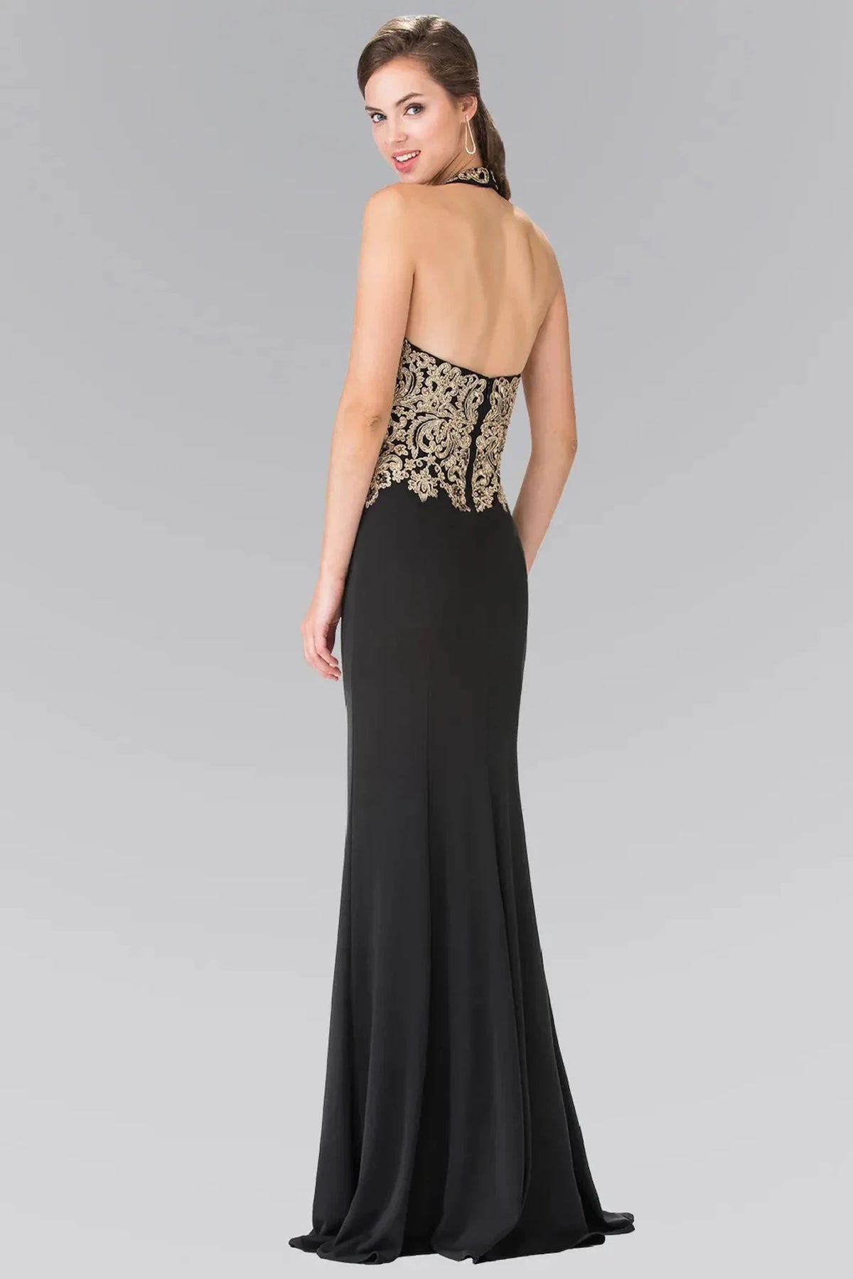 Rear view highlights the open back of the Black prom evening dress.