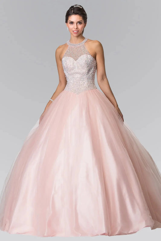 The Blush quinceañera ball gown appears head to toe with a crystal illusion halter bodice and soft blush skirt.