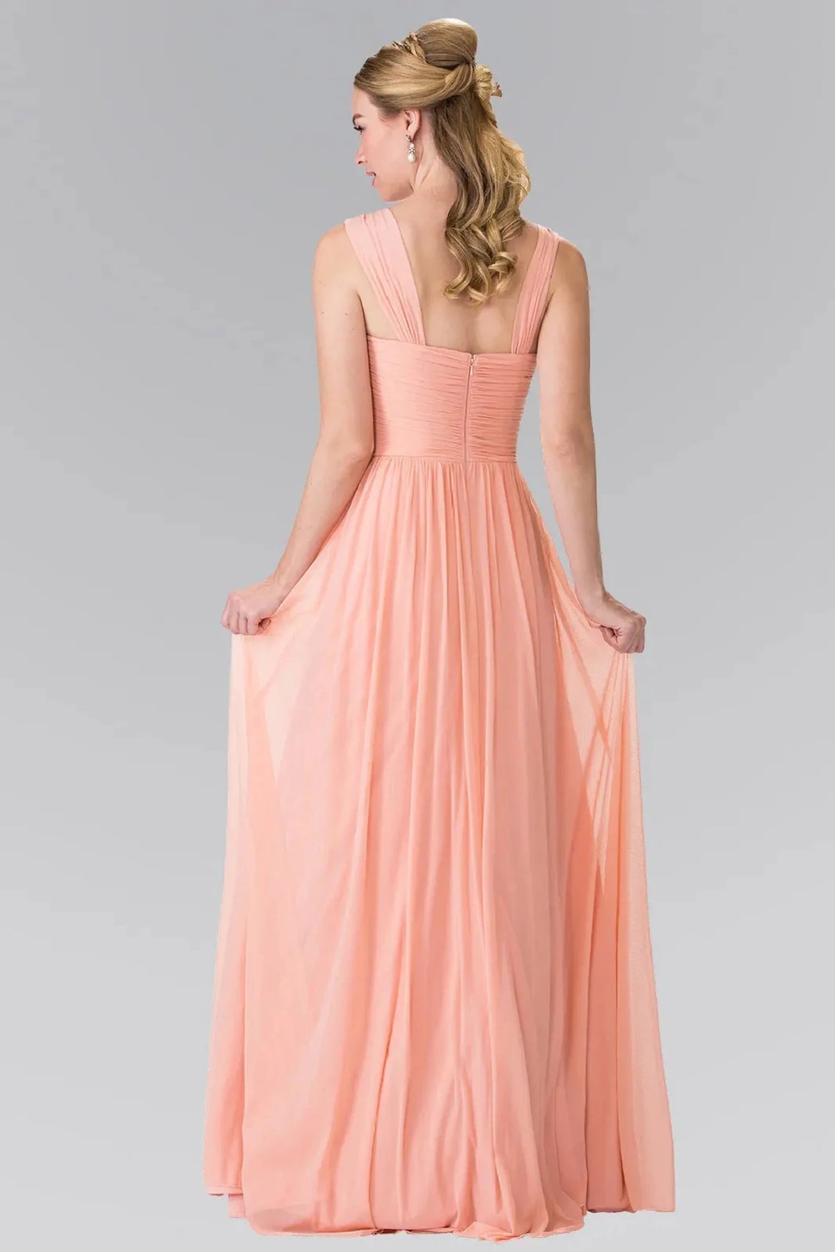 Rear view highlights the open back of the Coral prom evening dress.