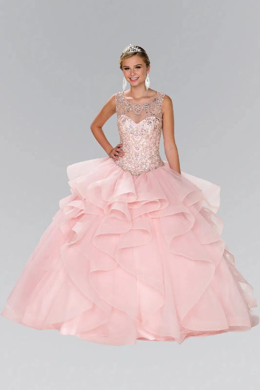 Full-length Blush quinceañera ball gown showcases a sheer jeweled neckline and dramatic layered tulle ruffles.