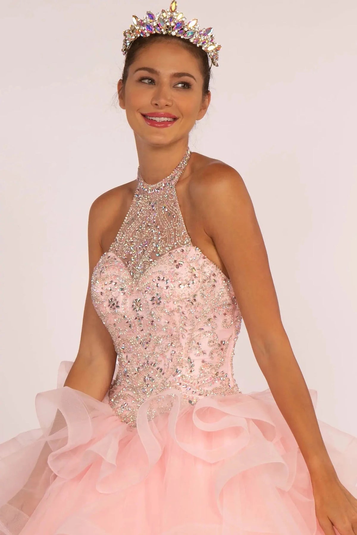 A front bodice close-up centers on the Baby Pink quinceañera ball gown and captures crystal embroidery across the high halter neckline.