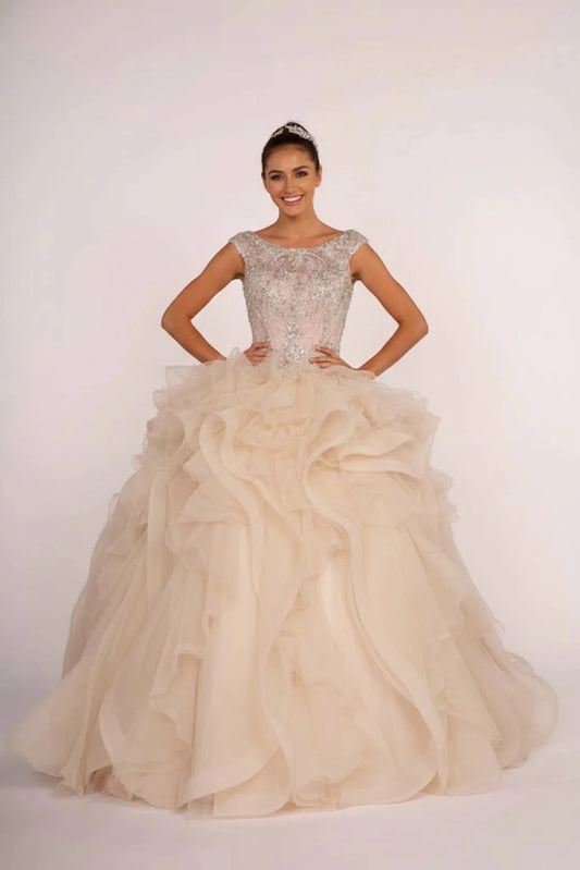 Sweeping Champagne quinceañera ball gown is shown in full with a cap-sleeve jeweled bodice and sweeping champagne ruffles.