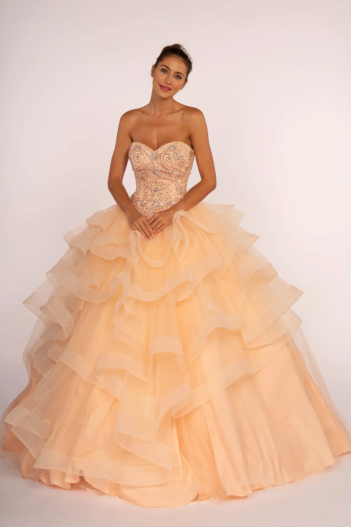 Full-length view presents the Peach quinceañera ball gown with rhinestone bodice.
