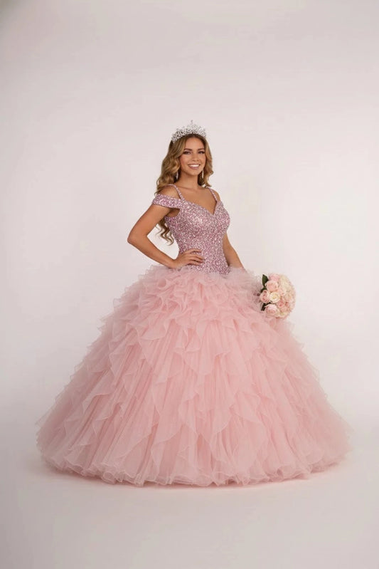 The Mauve quinceañera ball gown appears head to toe with a beaded off-shoulder bodice and soft mauve ruffles.