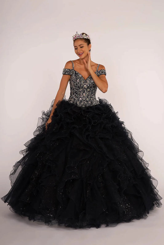 Sweeping Navy quinceañera ball gown is shown in full with a silver jeweled bodice and voluminous navy ruffle skirt.