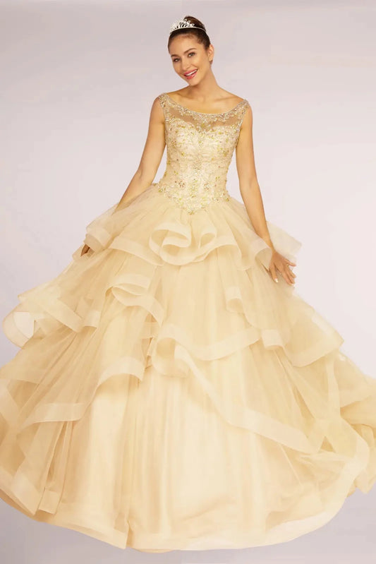 Displayed in full, the Champagne quinceañera ball gown features a beaded bateau bodice and airy champagne ruffles.