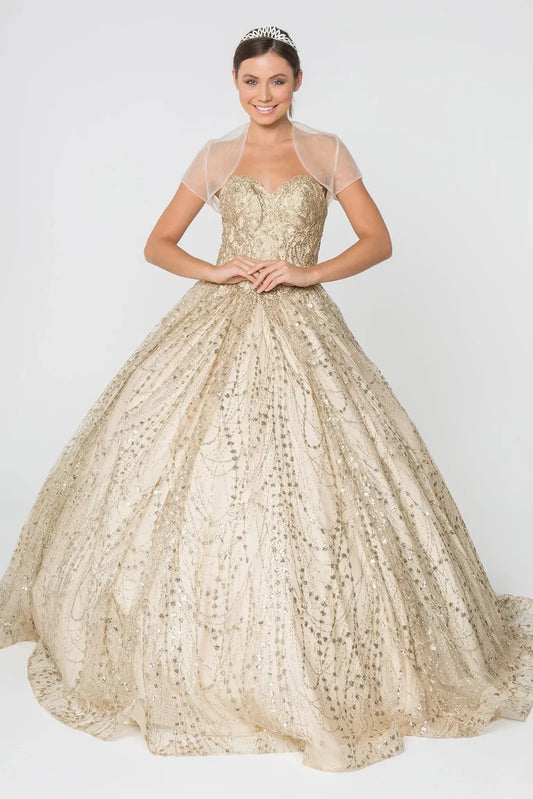Sweeping Champagne quinceañera ball gown is shown in full with a sheer bolero over a gold glitter corset and striped ball skirt.