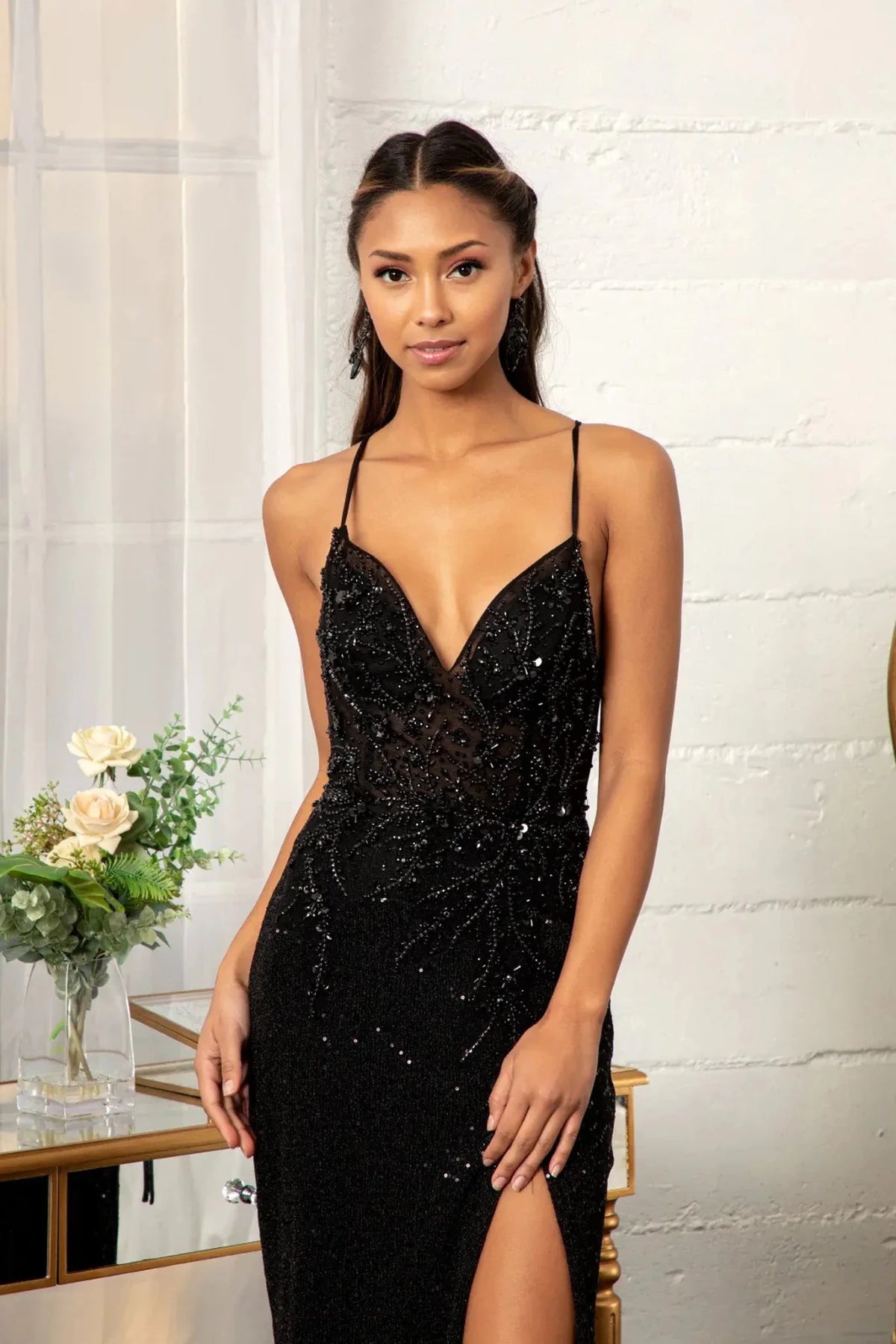 Bodice close-up reveals beadwork across the v-neck upper bodice of the Black prom evening dress.