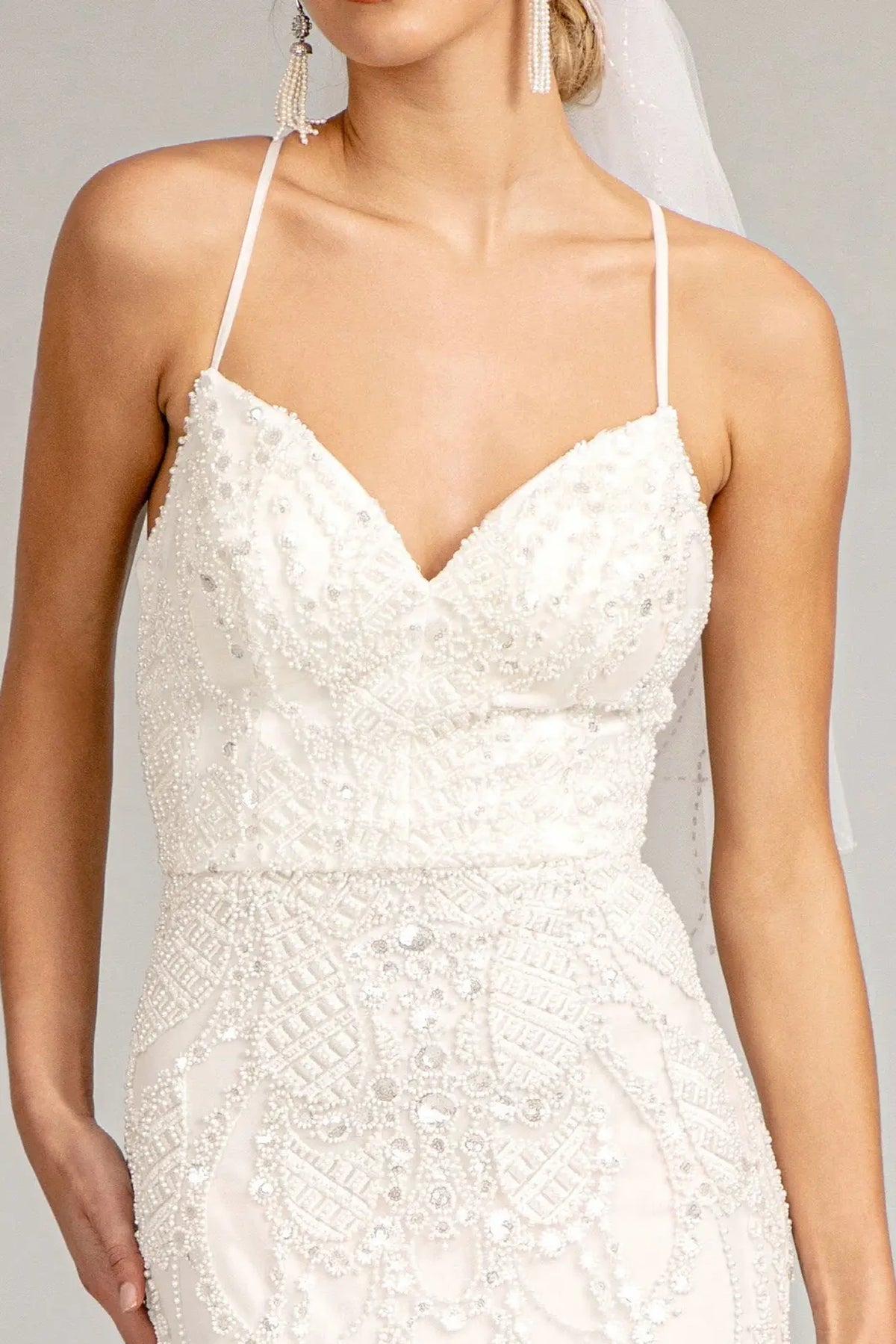 Ivory wedding gown with beaded floral embroidery shaping its sweetheart bodice.