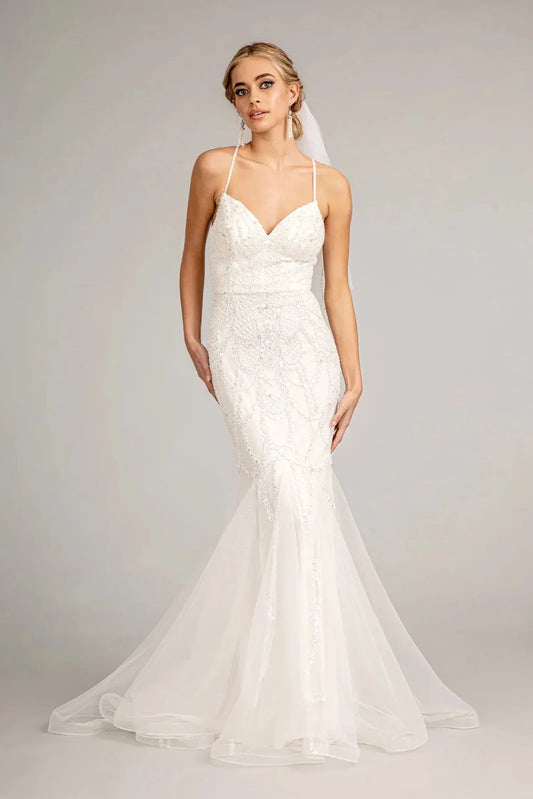 The fitted lace silhouette opens into a mesh mermaid hem on this ivory wedding gown.