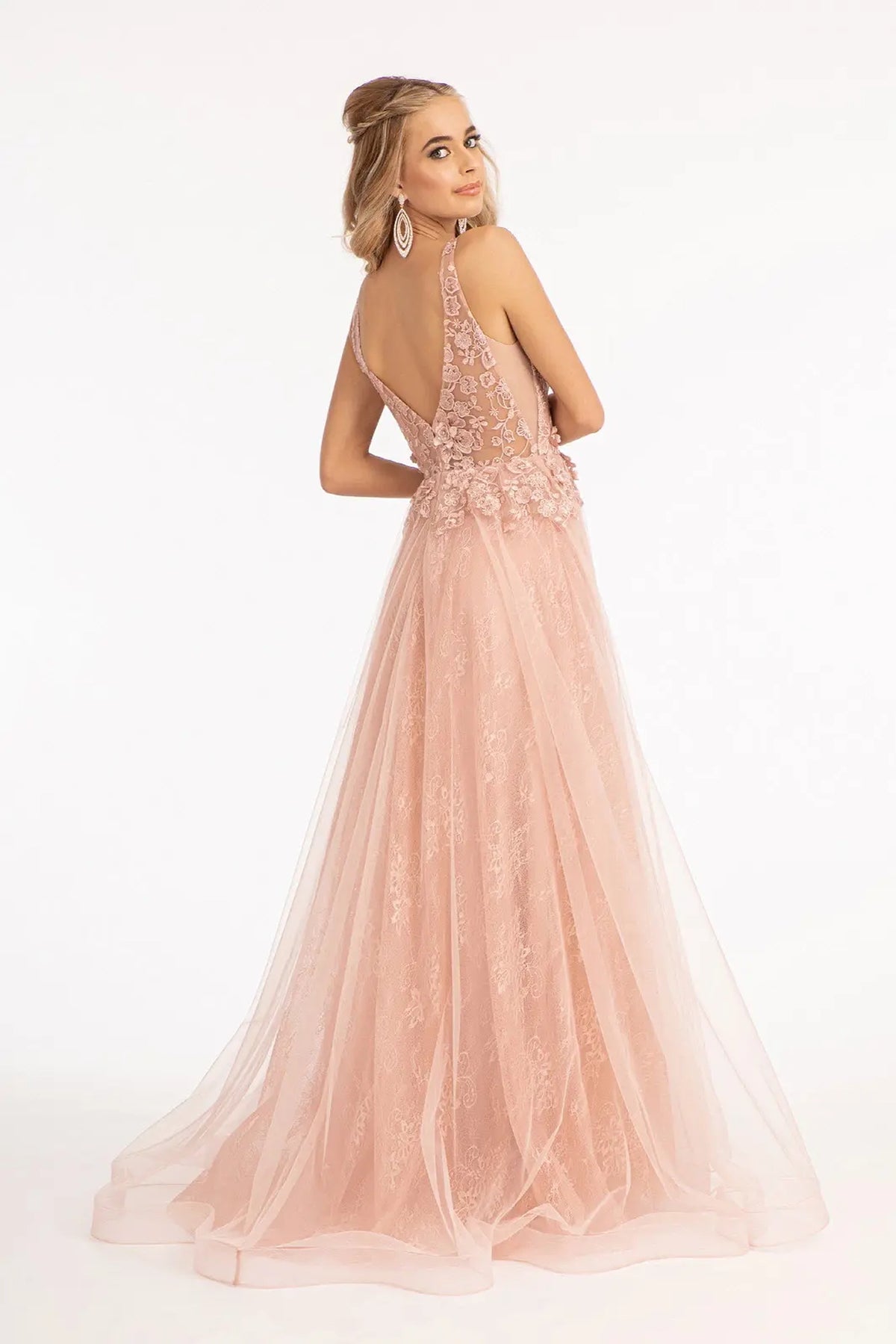 A sheer embroidered V-back tops the flowing skirt of the Rose Gold wedding gown.