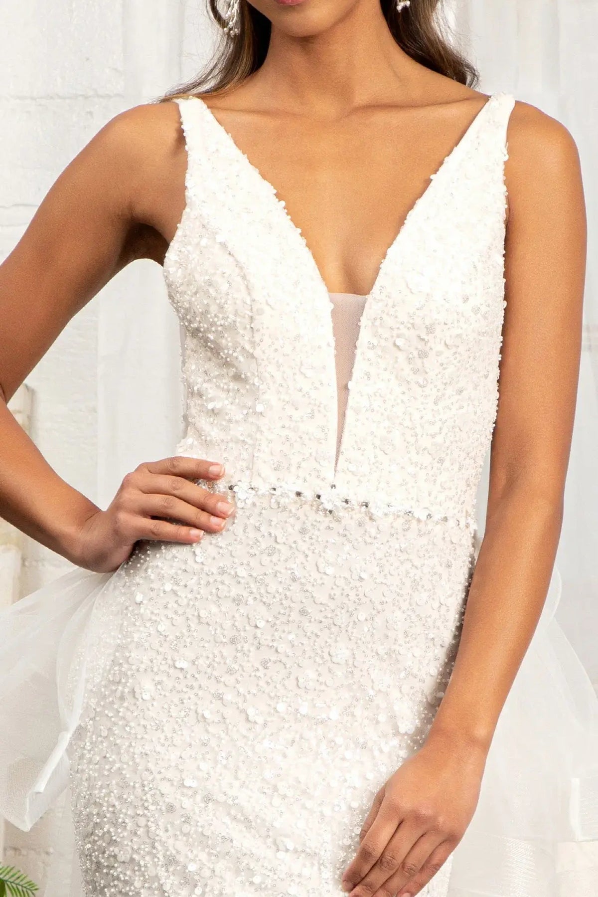 Illusion mesh fills the deep V-neckline of this Ivory/Champagne wedding gown, edged with beaded floral appliqués.