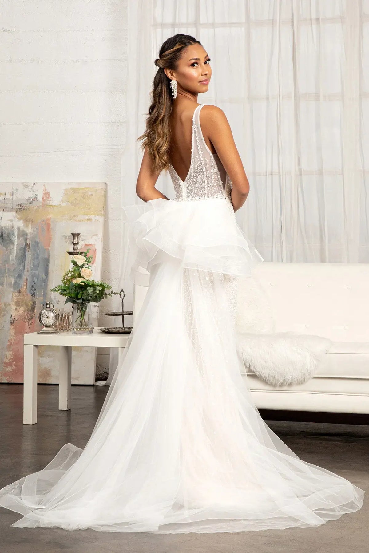 Gathered layers sweep into a long train behind the Ivory/Champagne wedding gown.