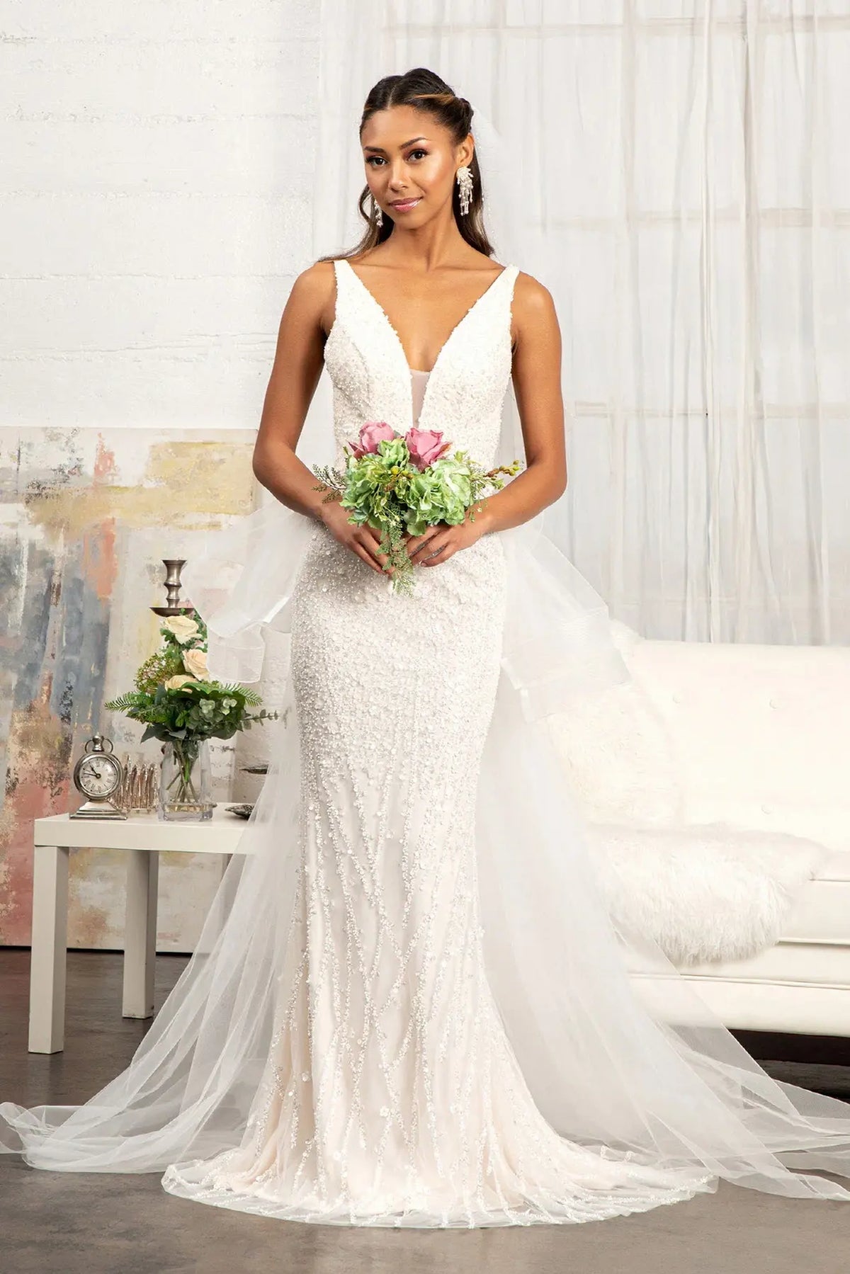 Beaded flowers cover the fitted skirt and bodice of this Ivory/Champagne wedding gown.