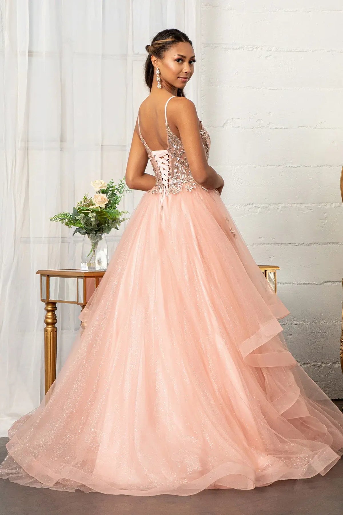 Bodice close-up highlights the Rose Gold quinceañera ball gown with glitter mesh skirt.