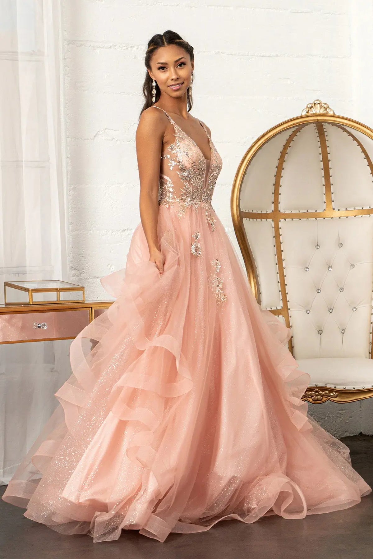 Layered skirt showcases the Rose Gold quinceañera ball gown with sheer sequin bodice.