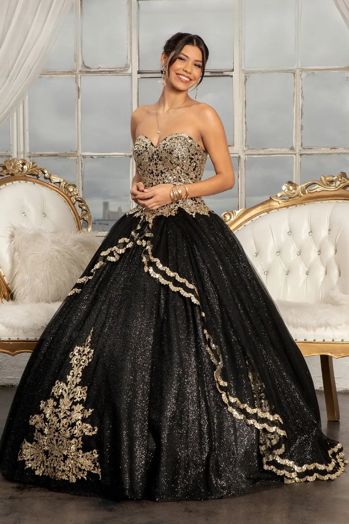 Lace-up back reveals the Black quinceañera ball gown with lace-up back and glitter mesh skirt.