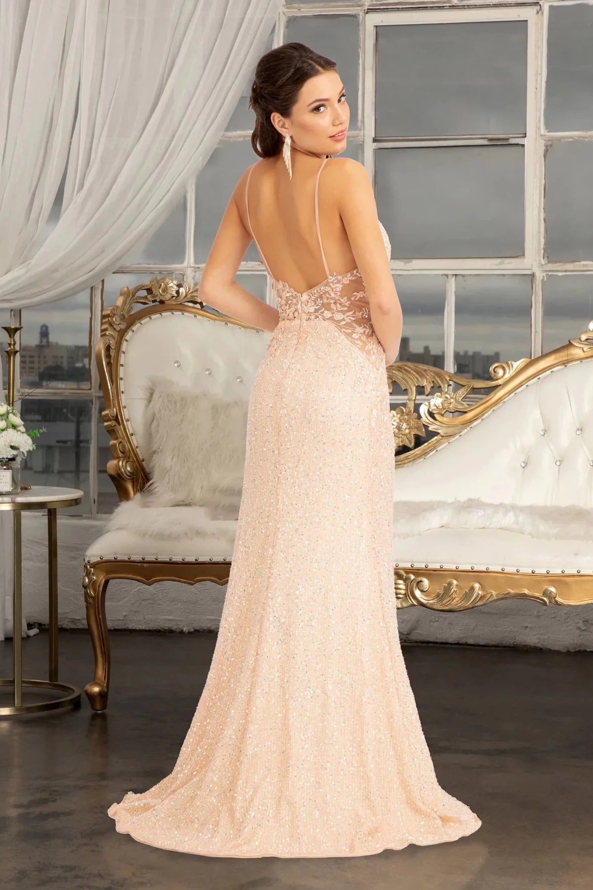 Rear view highlights the open back of the Champagne prom evening dress.