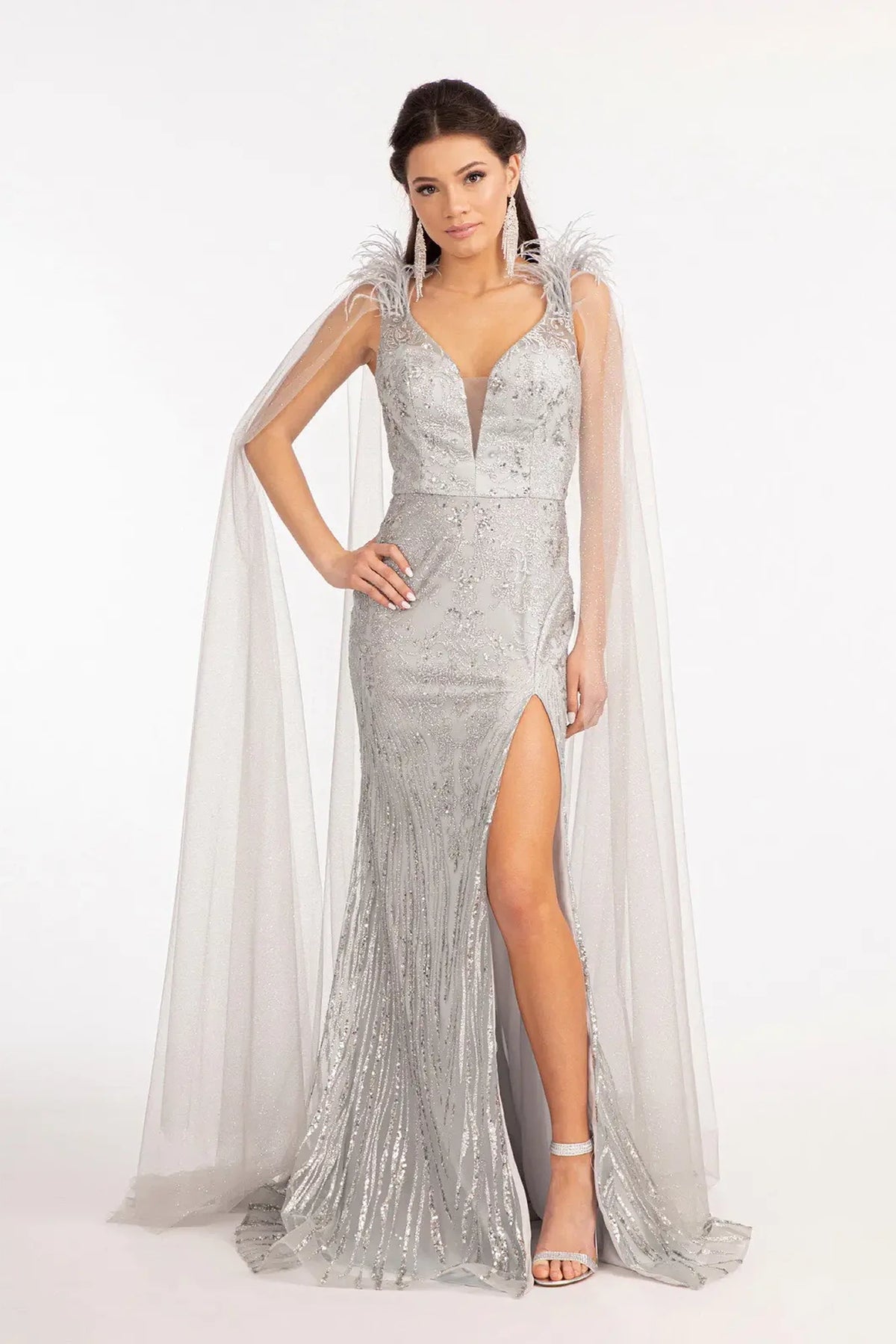 Silver mother of the bride dress with a high slit beneath feathered shoulders