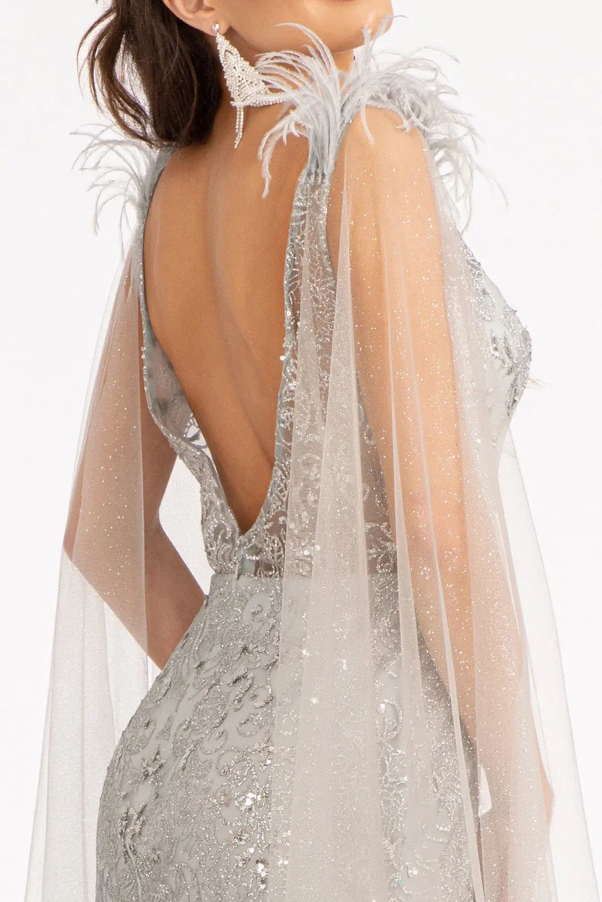 Silver mother of the bride dress with a low open back and feather-trimmed cape