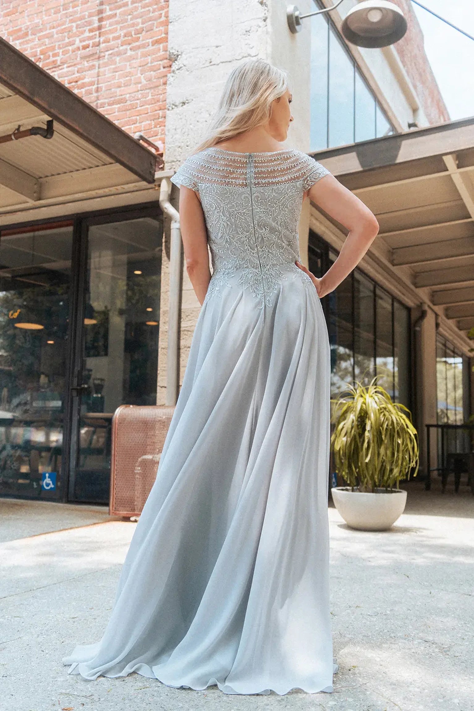 Silver mother of the bride dress featuring formal gown with boat-neck, cap sleeve, and chiffon skirt