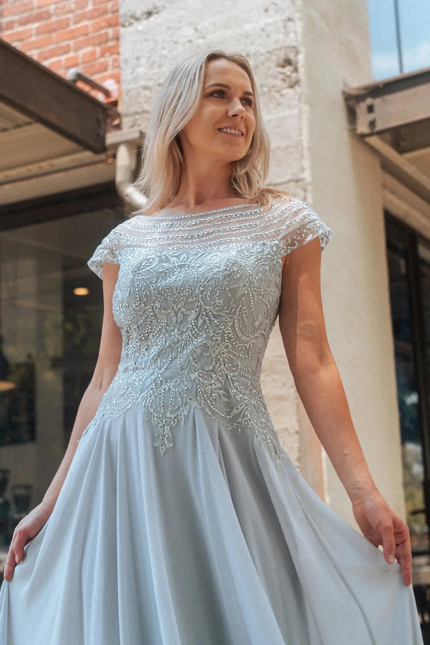 Silver mother of the bride dress featuring embellished bodice flowing into a chiffon a-line skirt