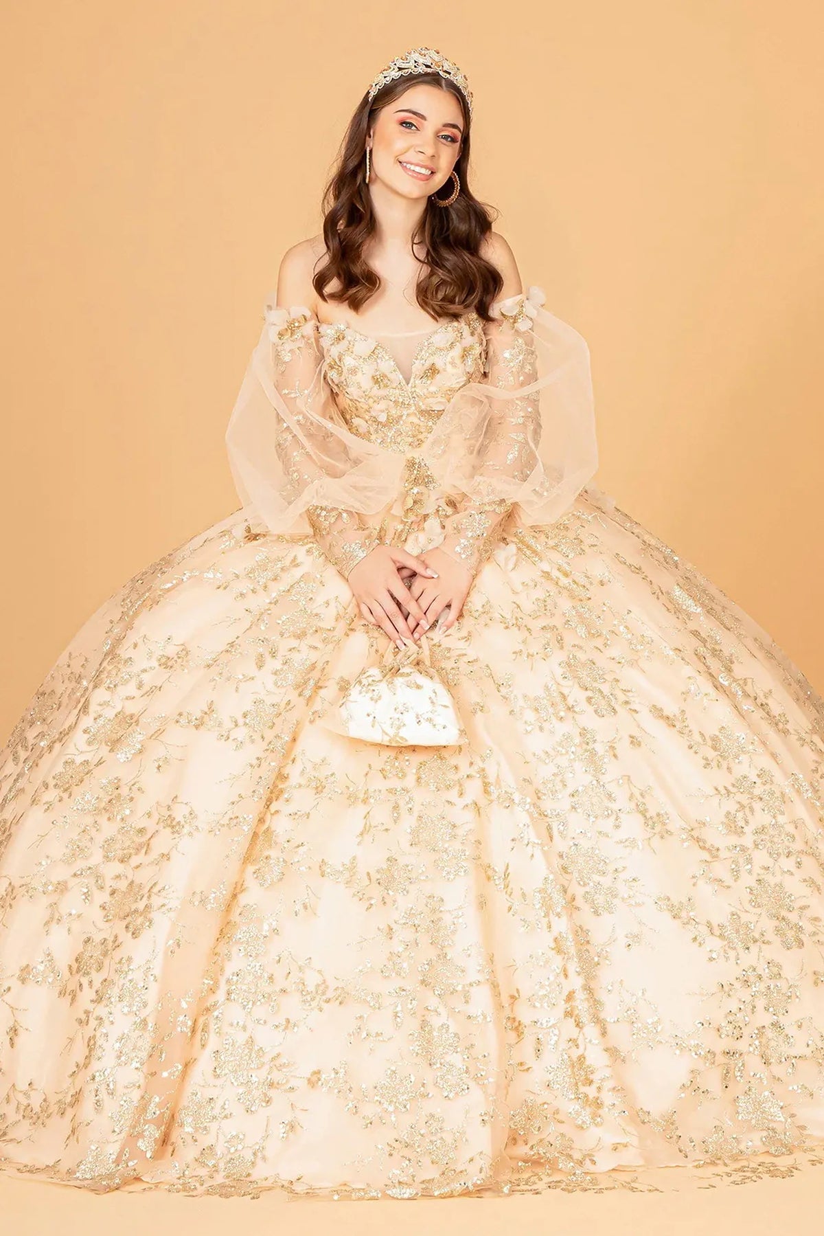 Lace-up back reveals the Gold quinceañera ball gown with lace-up back and long puff sleeves.