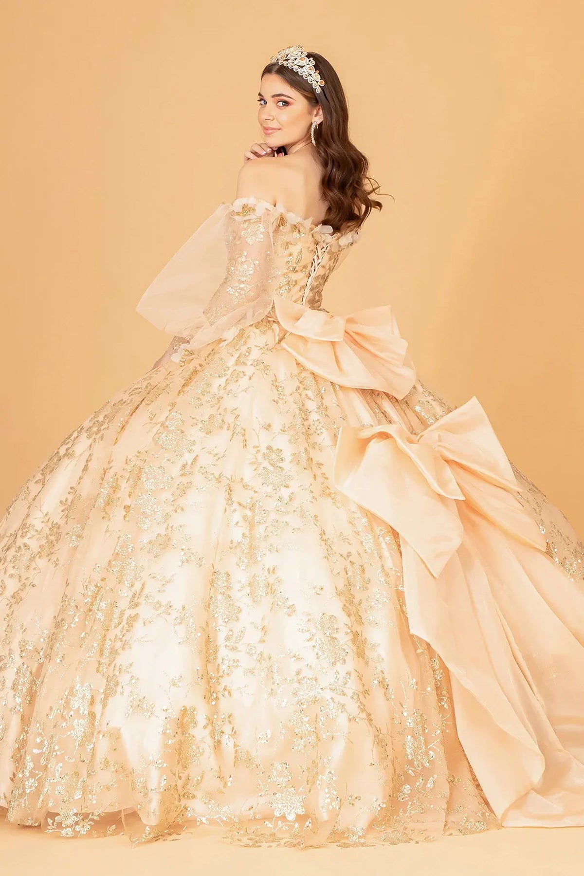 Bodice close-up highlights the Gold quinceañera ball gown with long puff sleeves.