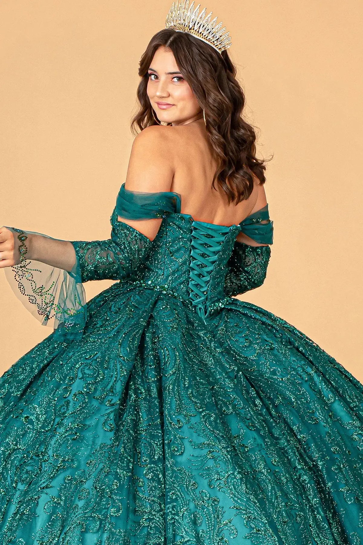 Embroidered details frame the Green quinceañera ball gown with detachable trumpet sleeves.