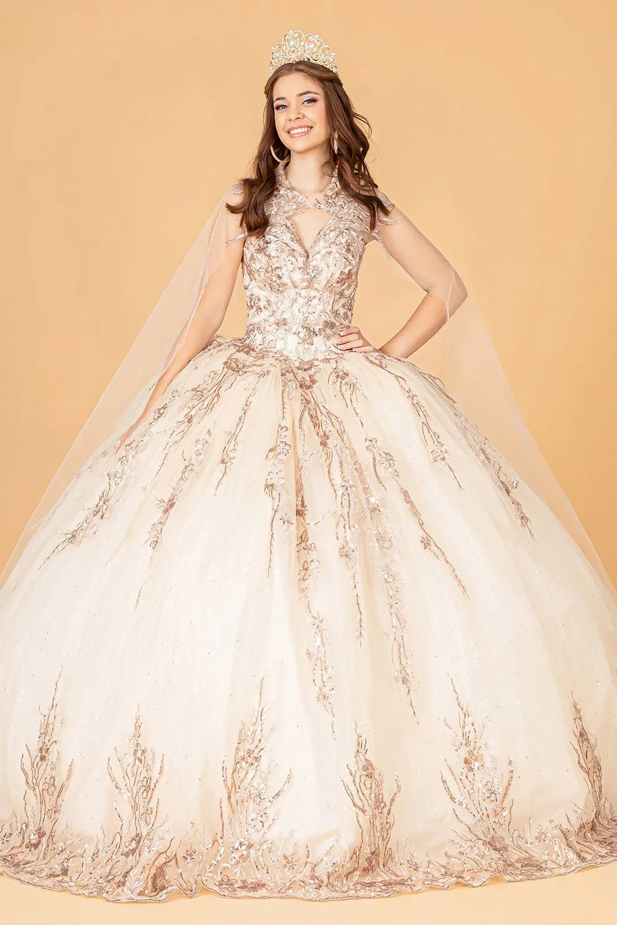 Lace-up back reveals the Champagne quinceañera ball gown with lace-up back and airy mesh cape.
