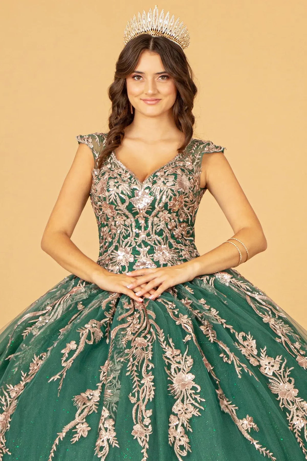 Full-length view presents the Green quinceañera ball gown with gold metallic embroidery.