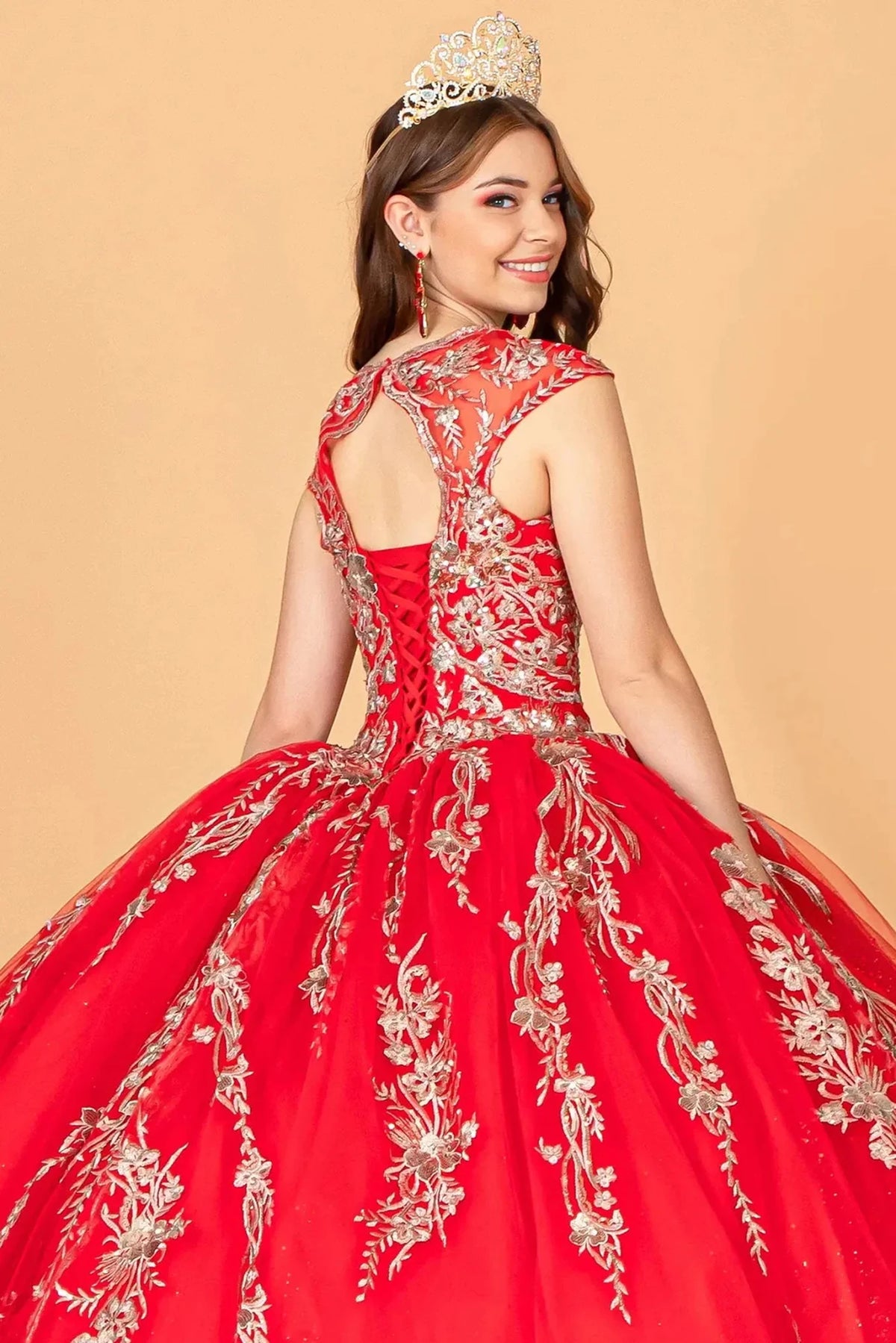 Layered skirt showcases the Red quinceañera ball gown with gold metallic embroidery.