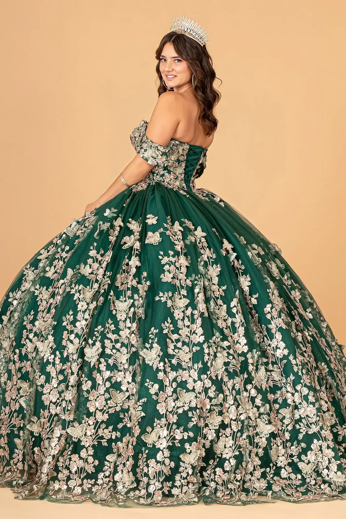 Bodice close-up highlights the Green quinceañera ball gown with gold metallic embroidery.