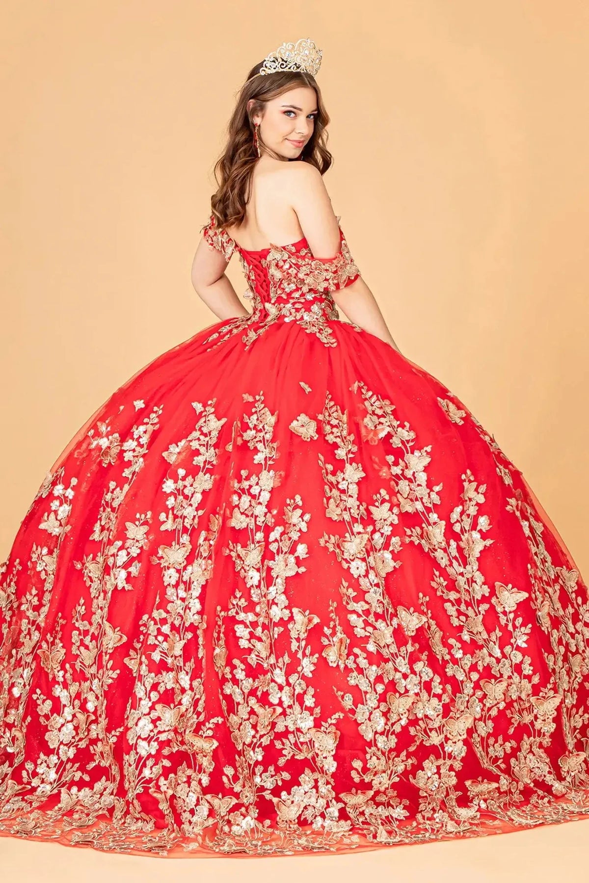 Bodice close-up highlights the Red quinceañera ball gown with gold metallic embroidery.