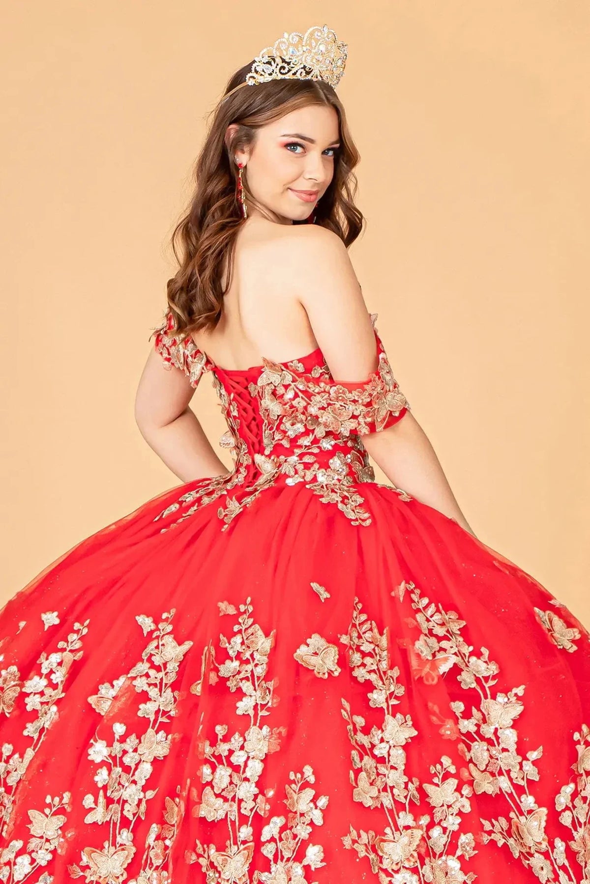 Layered skirt showcases the Red quinceañera ball gown with 3d butterfly appliqués.