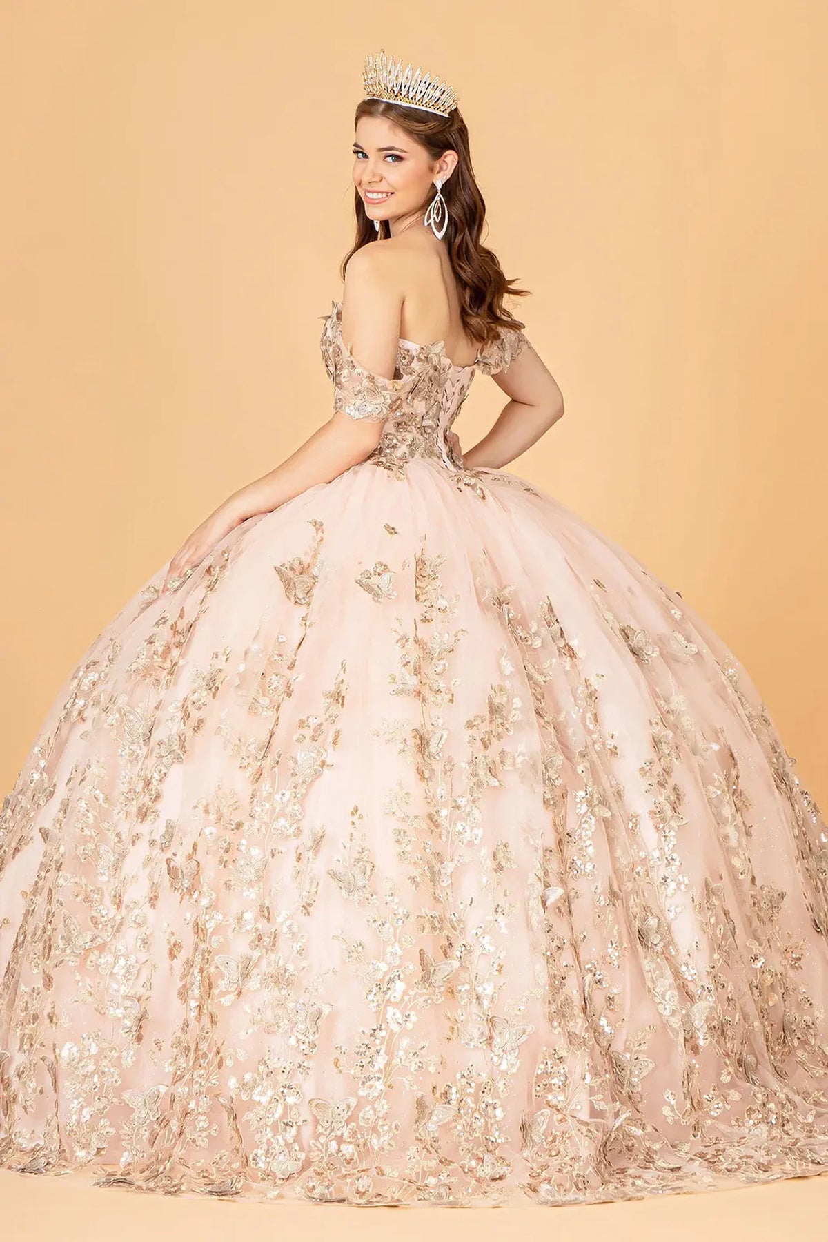 Bodice close-up highlights the Rose Gold quinceañera ball gown with gold metallic embroidery.