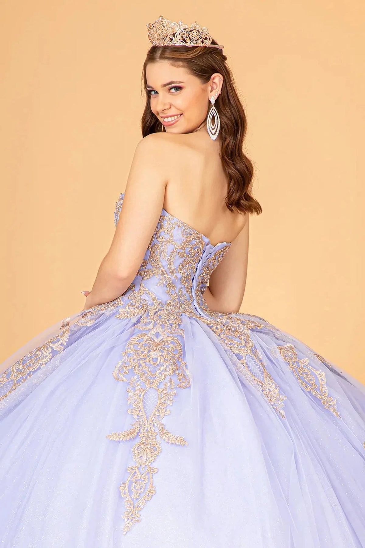 Layered skirt showcases the Lilac quinceañera ball gown with long embroidered cape.