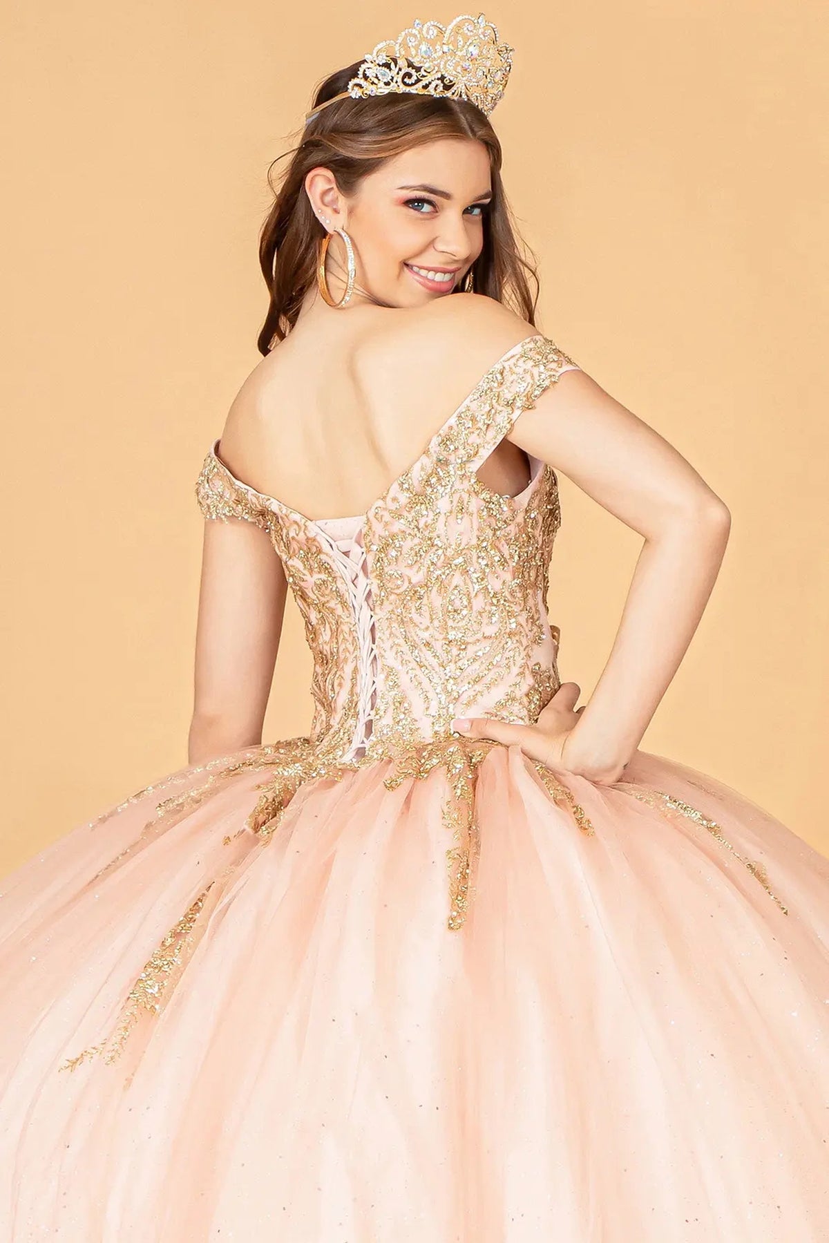 Embroidered details frame the Rose Gold quinceañera ball gown with gold metallic embroidery.