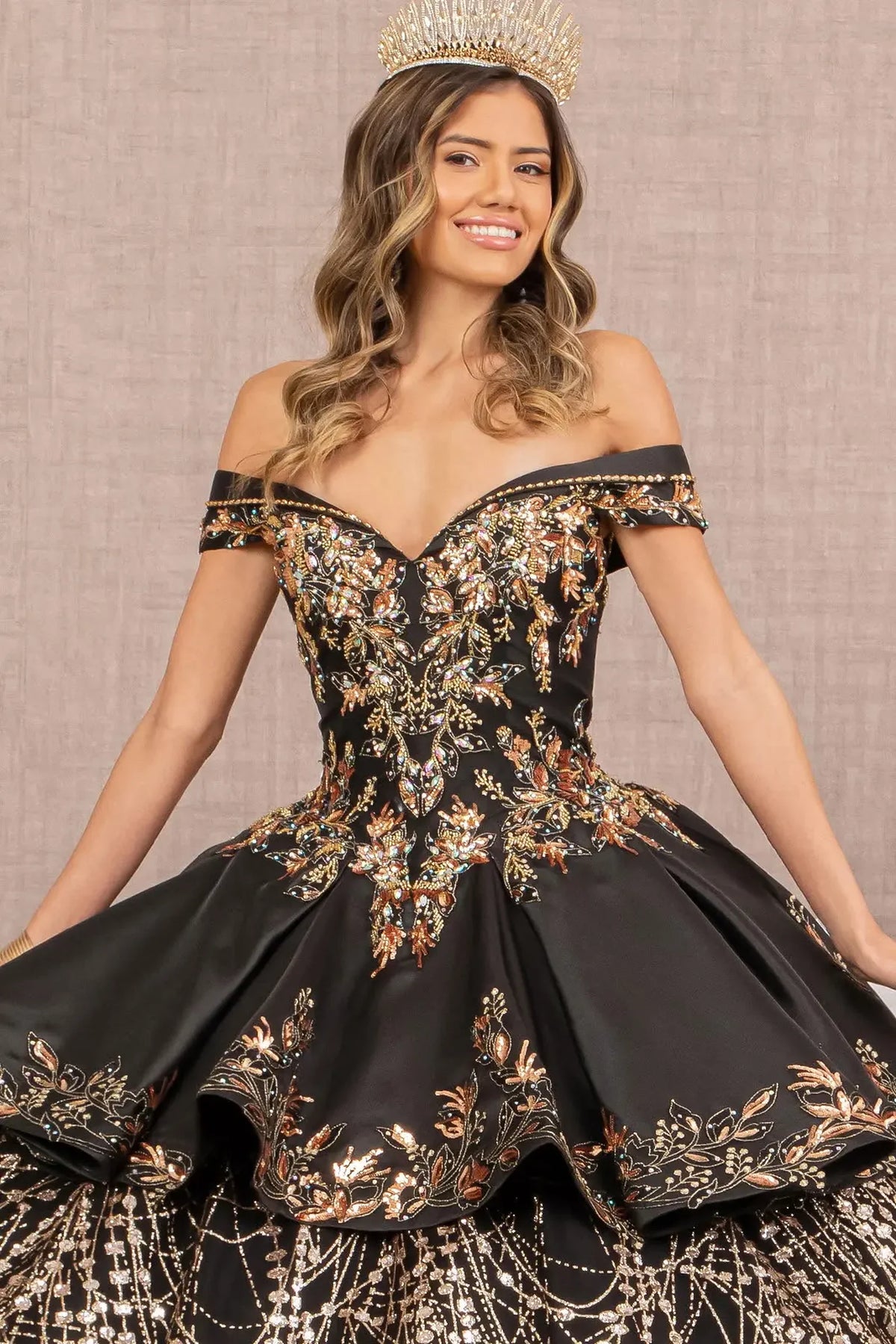 Full-length view presents the Black/Gold quinceañera ball gown with gold embroidered train.