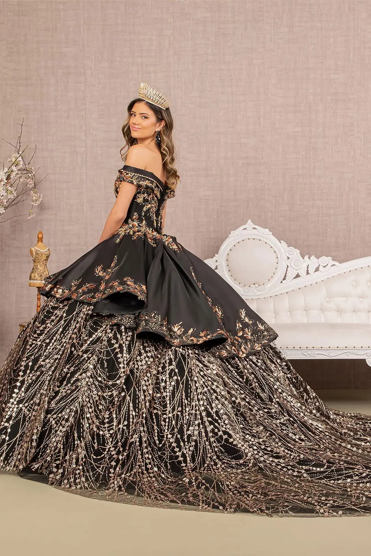 Bodice close-up highlights the Black/Gold quinceañera ball gown with convertible high-low skirt.