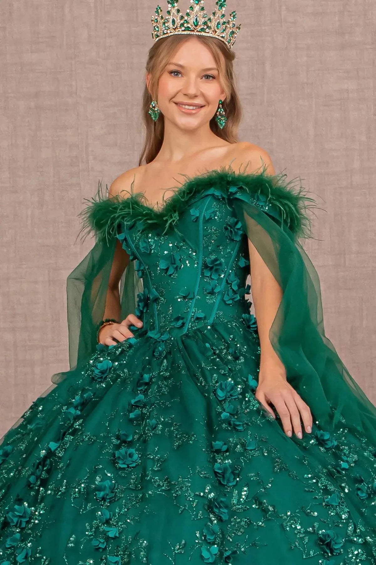 Full-length view presents the Green quinceañera ball gown with detachable feather trim.