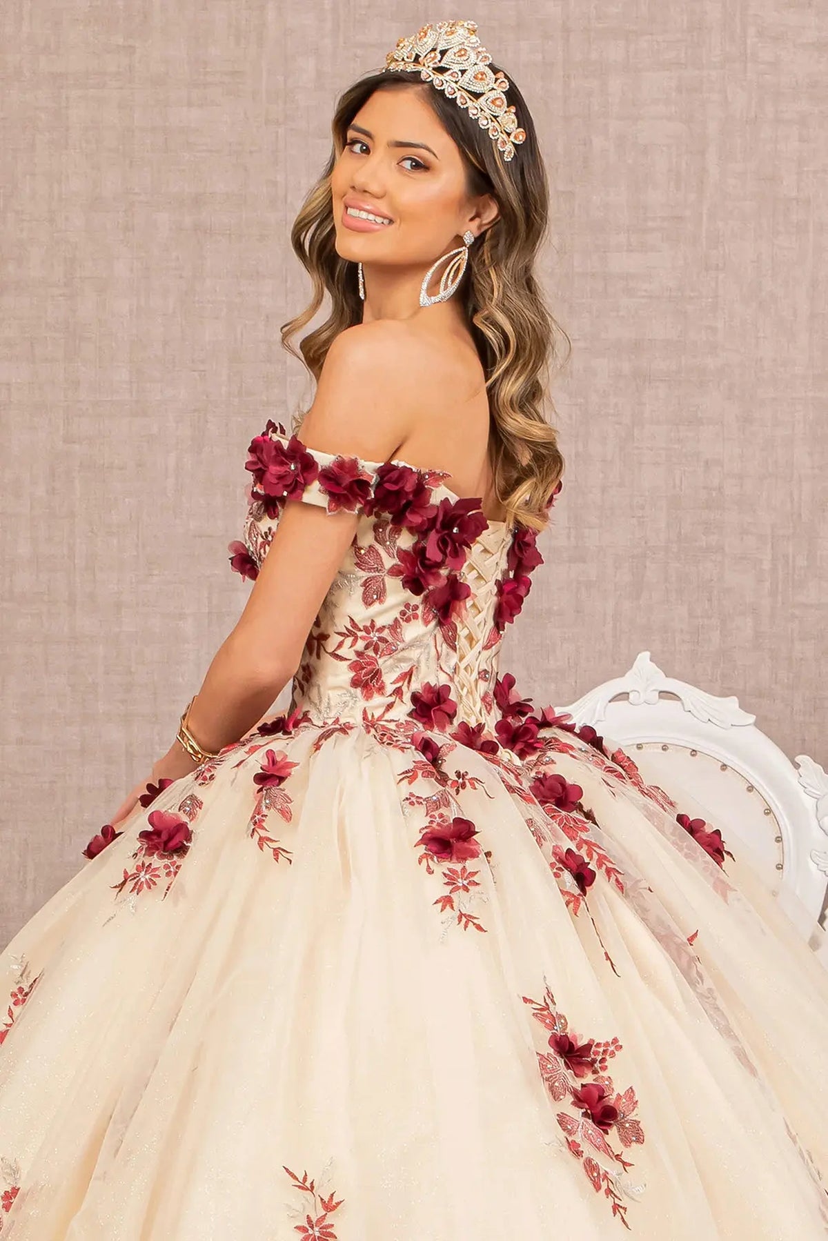 Layered skirt showcases the Burgundy/Nude quinceañera ball gown with 3d floral embroidery.