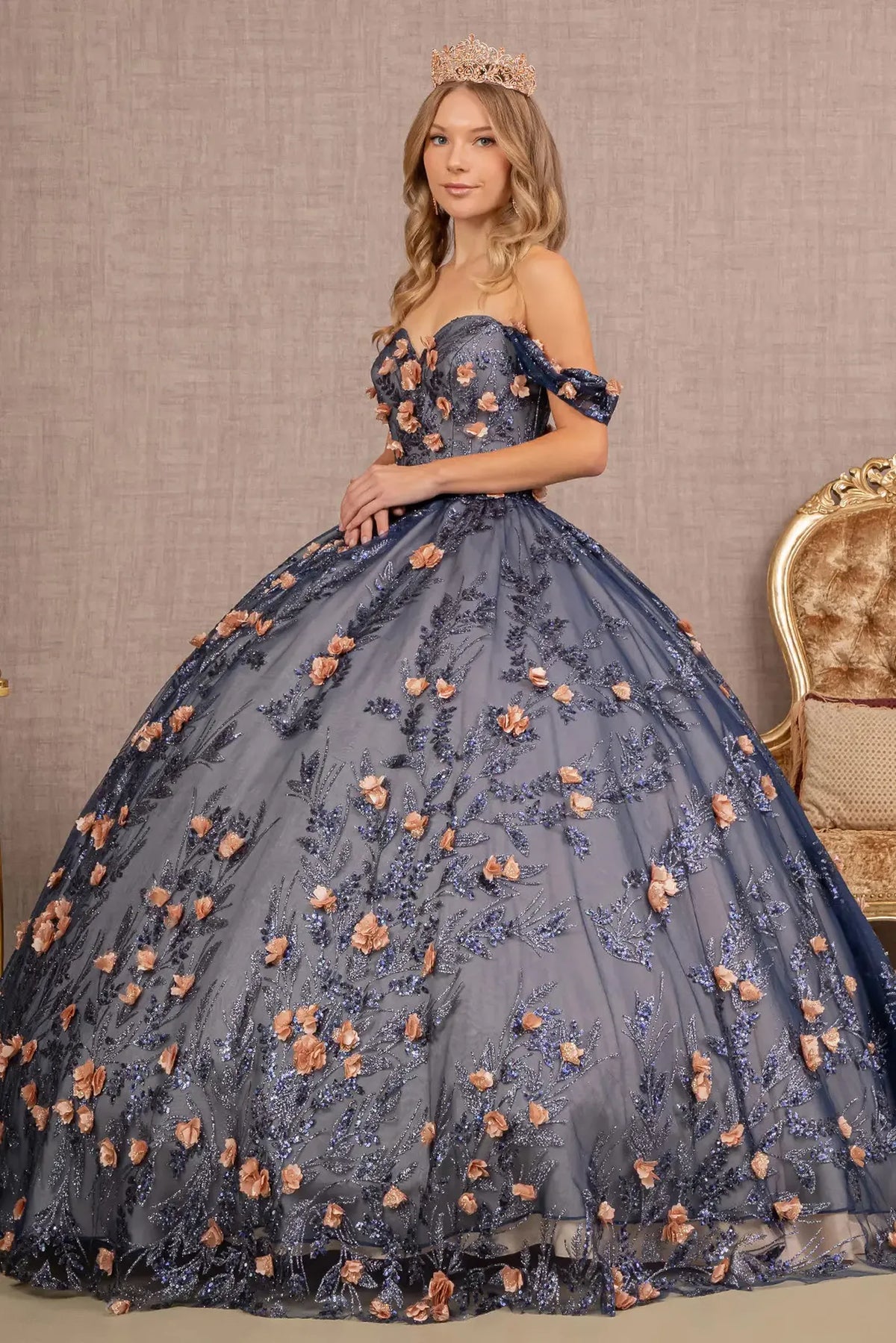 Embroidered details frame the Navy quinceañera ball gown with 3d floral appliqués.