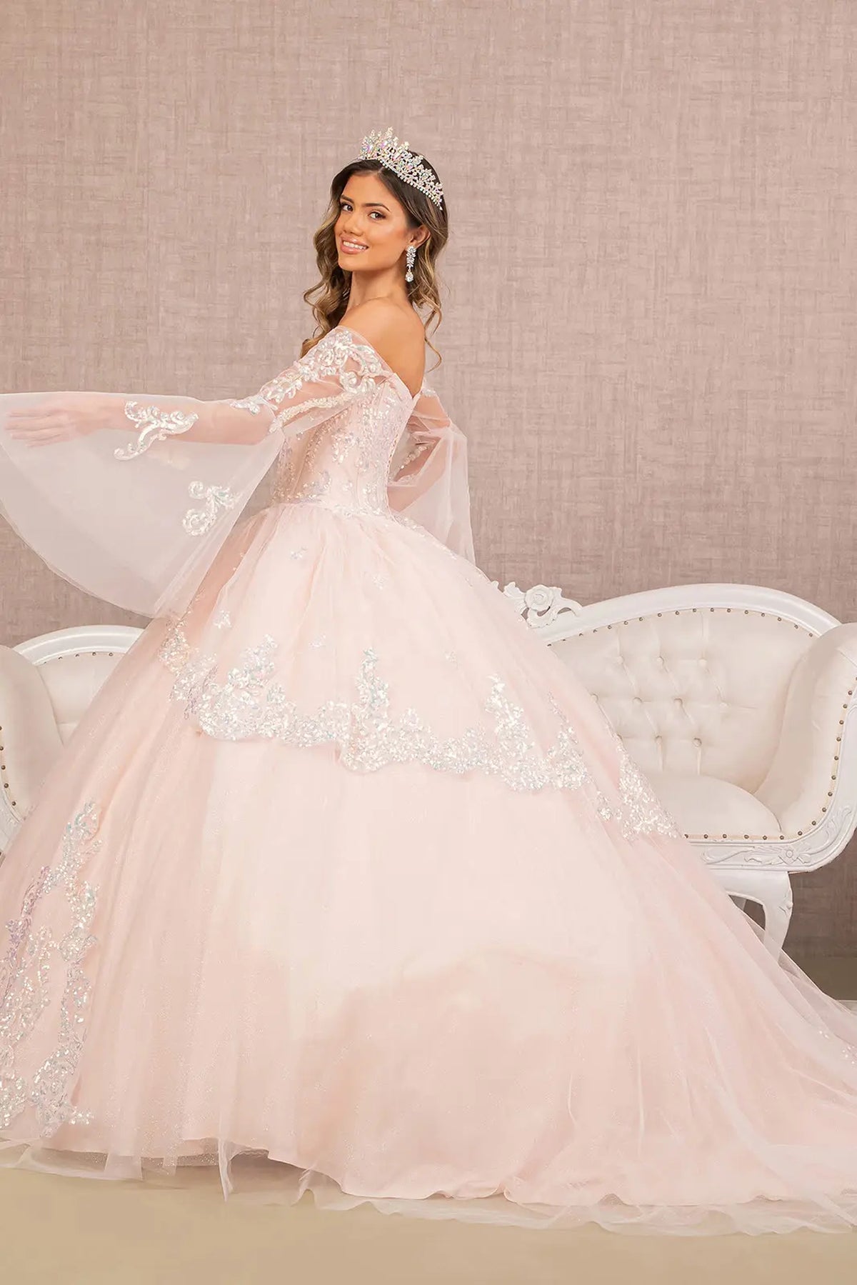 Bodice close-up highlights the Blush quinceañera ball gown with long mesh sleeves.